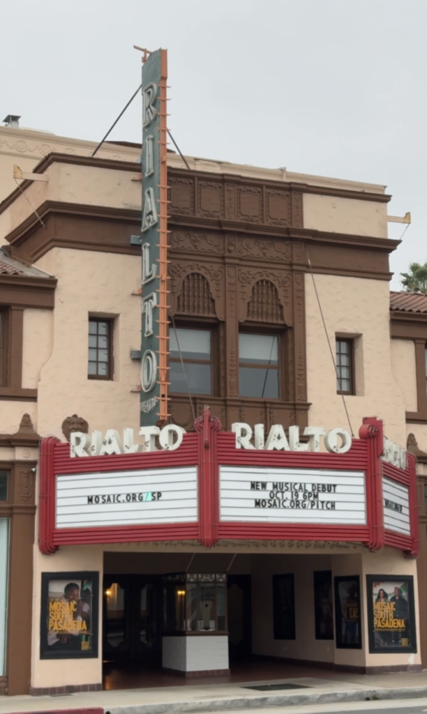 An old looking movie theatre with a red marquis reading Rialto